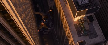 Movie still from “The Matrix Resurrections” (2021), directed by Lana Wachowski – Two people are jumping in the air in the dark; Wide shot, Overhead angle