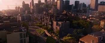 Movie still from “The Matrix Resurrections” (2021), directed by Lana Wachowski – An aerial view of a large city with buildings and trees; Extreme Wide shot, High angle