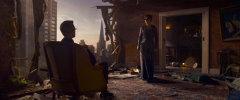 Movie still from “The Matrix Resurrections” (2021), directed by Lana Wachowski – A woman standing on a balcony next to a man; Wide shot, Low angle