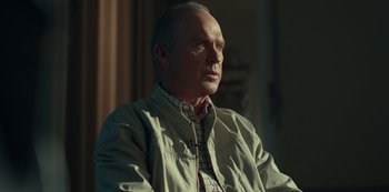 Movie still from “Dopesick” (2021), directed by Danny Strong – An older man sitting in front of a window; Close Up shot, Low angle