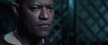 Movie still from “The Matrix Revolutions” (2003), directed by Lilly Wachowski – A man's face in a dark room; Close Up shot, Low angle