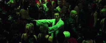 Movie still from “The Matrix Revolutions” (2003), directed by Lilly Wachowski – A group of people standing around in a room; Medium shot, High angle
