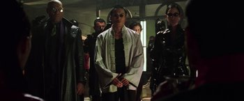 Movie still from “The Matrix Revolutions” (2003), directed by Lilly Wachowski – A group of people standing in a room holding swords; Medium shot, Low angle