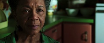 Movie still from “The Matrix Revolutions” (2003), directed by Lilly Wachowski – An older woman is looking into the camera; Close Up shot, Low angle