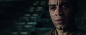Movie still from “The Matrix Revolutions” (2003), directed by Lilly Wachowski – A man's face in a dark room; Close Up shot, Low angle