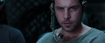 Movie still from “The Matrix Revolutions” (2003), directed by Lilly Wachowski – A person with a chain around their neck; Close Up shot, Overhead angle