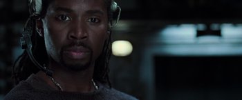 Movie still from “The Matrix Revolutions” (2003), directed by Lilly Wachowski – A person wearing headphones; Close Up shot, Low angle