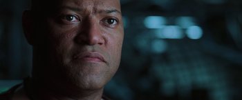 Movie still from “The Matrix Revolutions” (2003), directed by Lilly Wachowski – A man's face in a dark room; Close Up shot, Low angle