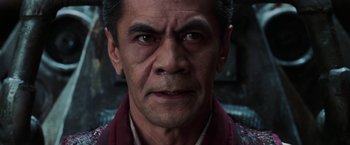 Movie still from “The Matrix Revolutions” (2003), directed by Lilly Wachowski – A man's face in a dark room; Close Up shot, Low angle