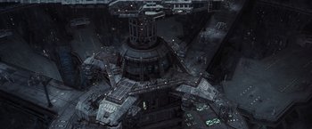 Movie still from “The Matrix Revolutions” (2003), directed by Lilly Wachowski – An aerial view of a large building with many lights; Extreme Wide shot, Overhead angle