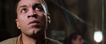 Movie still from “The Matrix Revolutions” (2003), directed by Lilly Wachowski – A person looking up at the sky; Close Up shot, Low angle