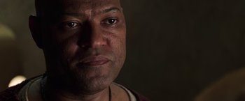 Movie still from “The Matrix Revolutions” (2003), directed by Lilly Wachowski – A man's face in a darkened room; Close Up shot, Low angle