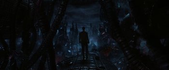 Movie still from “The Matrix Revolutions” (2003), directed by Lilly Wachowski – A man standing on a platform in the middle of a city; Extreme Wide shot, High angle