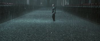 Movie still from “The Matrix Revolutions” (2003), directed by Lilly Wachowski – A man standing in the middle of a rain storm; Extreme Wide shot, High angle