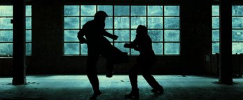 Movie still from “The Matrix Revolutions” (2003), directed by Lilly Wachowski – A couple of people that are in the dark; Wide shot, Low angle