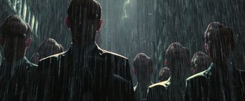 Movie still from “The Matrix Revolutions” (2003), directed by Lilly Wachowski – A group of people standing in the rain; Medium shot, Low angle