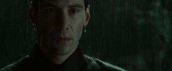 Movie still from “The Matrix Revolutions” (2003), directed by Lilly Wachowski – A person wearing a jacket; Close Up shot, Over the shoulder angle