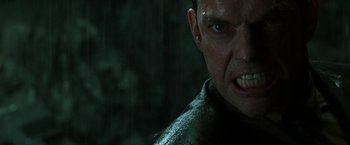 Movie still from “The Matrix Revolutions” (2003), directed by Lilly Wachowski – A man's angry face in the rain; Close Up shot, Low angle