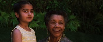 Movie still from “The Matrix Revolutions” (2003), directed by Lilly Wachowski – An older woman standing next to a young girl; Close Up shot, Low angle
