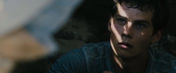 Movie still from “The Maze Runner” (2014), directed by Wes Ball – A young man's face in the dark; Close Up shot, Low angle