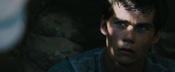 Movie still from “The Maze Runner” (2014), directed by Wes Ball – A young man's face in the dark; Close Up shot, Low angle