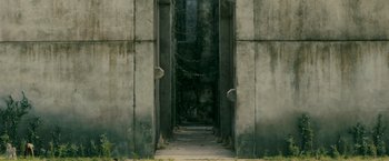 Movie still from “The Maze Runner” (2014), directed by Wes Ball – An open door leading to a very dark place; Extreme Wide shot, High angle