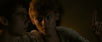 Movie still from “The Maze Runner” (2014), directed by Wes Ball – A young man with a messy hair style; Close Up shot, Over the shoulder angle
