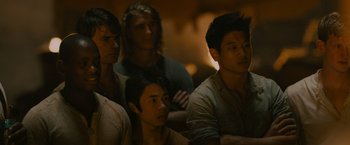 Movie still from “The Maze Runner” (2014), directed by Wes Ball – A group of people sitting in a room; Close Up shot, Over the shoulder angle