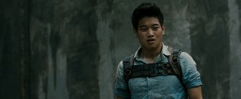 Movie still from “The Maze Runner” (2014), directed by Wes Ball – A young man wearing a leather harness and a denim shirt; Close Up shot, Over the shoulder angle