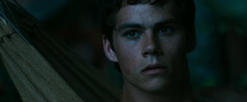 Movie still from “The Maze Runner” (2014), directed by Wes Ball – A young man's face in the dark; Close Up shot, Low angle