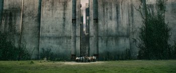 Movie still from “The Maze Runner” (2014), directed by Wes Ball – A group of people standing in front of a tall building; Extreme Wide shot, Low angle