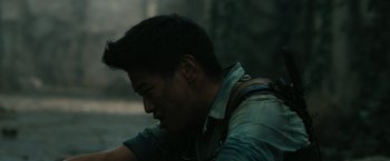 Movie still from “The Maze Runner” (2014), directed by Wes Ball – A man with a backpack is looking down at his shoulder; Close Up shot, Over the shoulder angle