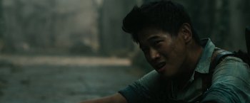 Movie still from “The Maze Runner” (2014), directed by Wes Ball – A young man sitting on the ground in the rain; Close Up shot, Over the shoulder angle