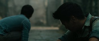 Movie still from “The Maze Runner” (2014), directed by Wes Ball – Two young men are playing a game in the dark; Close Up shot, Over the shoulder angle