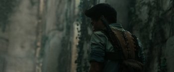 Movie still from “The Maze Runner” (2014), directed by Wes Ball – A young man holding a cell phone up to his ear; Close Up shot, Over the shoulder angle