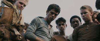 Movie still from “The Maze Runner” (2014), directed by Wes Ball – A group of young men standing next to each other; Medium shot, Low angle