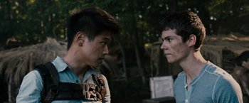 Movie still from “The Maze Runner” (2014), directed by Wes Ball – Two young men standing next to each other in a forest; Close Up shot, Over the shoulder angle