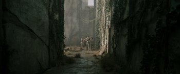 Movie still from “The Maze Runner” (2014), directed by Wes Ball – A group of people walking through a forest; Extreme Wide shot, High angle
