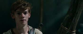 Movie still from “The Maze Runner” (2014), directed by Wes Ball – A young man holding a cell phone in his hand; Close Up shot, Over the shoulder angle