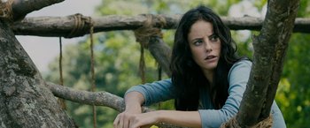 Movie still from “The Maze Runner” (2014), directed by Wes Ball – A woman leaning on a tree branch in the woods; Close Up shot, Low angle