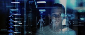 Movie still from “The Maze Runner” (2014), directed by Wes Ball – A man is looking at a hologram of a person; Extreme Close Up shot, Low angle