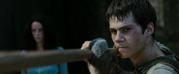 Movie still from “The Maze Runner” (2014), directed by Wes Ball – A young man holding a baseball bat in his hands; Close Up shot, Over the shoulder angle