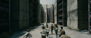 Movie still from “The Maze Runner” (2014), directed by Wes Ball – A group of people walking down a street; Extreme Wide shot, High angle