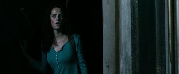 Movie still from “The Maze Runner” (2014), directed by Wes Ball – A woman standing in a dark room with a backpack; Close Up shot, Low angle