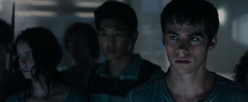 Movie still from “The Maze Runner” (2014), directed by Wes Ball – A group of young men standing next to each other in a dark room; Close Up shot, Over the shoulder angle