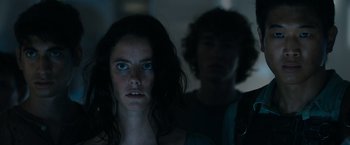 Movie still from “The Maze Runner” (2014), directed by Wes Ball – A woman and a man standing next to each other in the dark; Close Up shot, Low angle