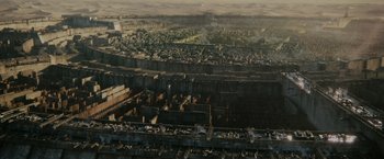 Movie still from “The Maze Runner” (2014), directed by Wes Ball – An aerial view of an industrial area in a city; Extreme Wide shot, High angle