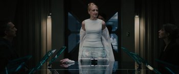 Movie still from “The Maze Runner” (2014), directed by Wes Ball – A woman standing in front of a glass table; Medium shot, Over the shoulder angle