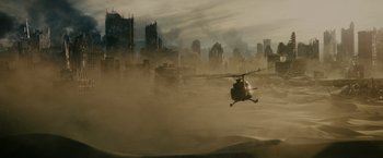 Movie still from “The Maze Runner” (2014), directed by Wes Ball – A helicopter is flying over a city in the fog; Extreme Wide shot, High angle