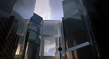 Movie still from “The Meaning of Life” (1983), directed by Terry Jones – Looking up at a skyscraper in a city; Extreme Wide shot, Low angle